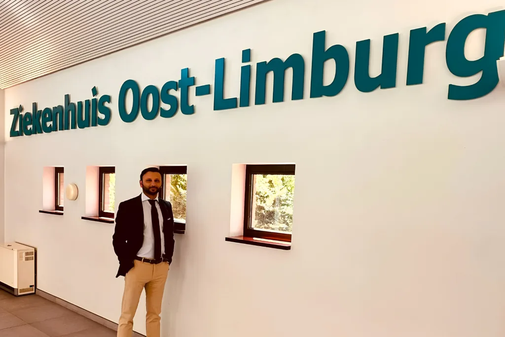 Prof. Dr. Sami Hassan standing in a suit in a hospital hallway